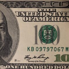 Detailed close-up image of a US one hundred dollar bill showing Benjamin Franklin.