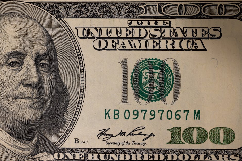 Detailed close-up image of a US one hundred dollar bill showing Benjamin Franklin.