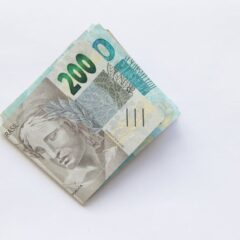 Stack of 200 Brazilian Real banknotes isolated on a white surface, symbolizing wealth and finance.