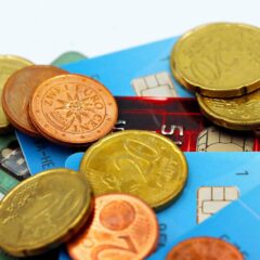 Close-up image of Euro coins and credit cards representing modern financial transactions.