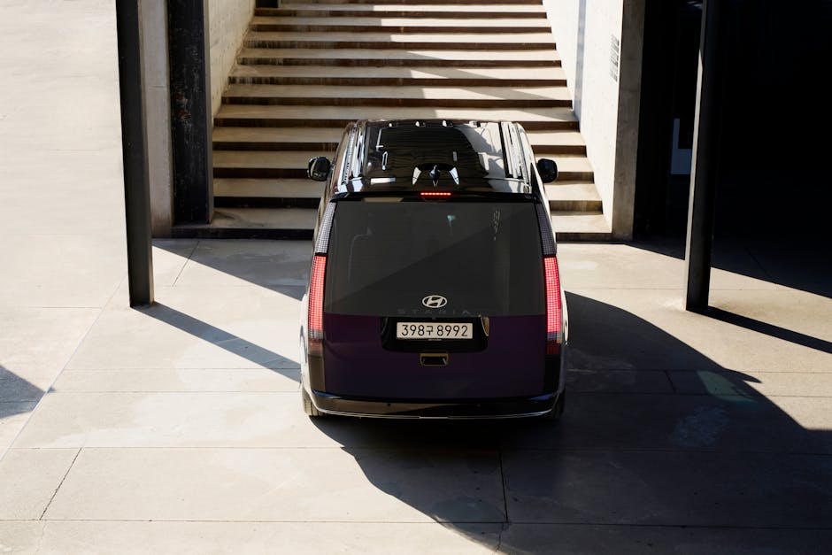 A Hyundai Staria Lounge Hybrid parked outdoors, showcasing modern design and mobility.