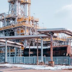 Oil refinery facility with tanker wagons in Trzebinia, Lesser Poland Voivodeship under a clear sky.