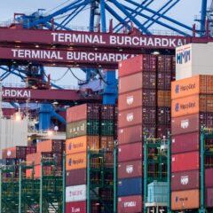 View of shipping containers and cranes at Hamburg's Burchardkai terminal.
