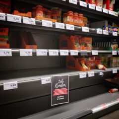 Half empty shelves with assorted products in jars and containers in supermarket during quarantine