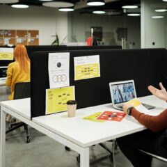 Colleagues working and collaborating virtually at a stylish modern office workspace.