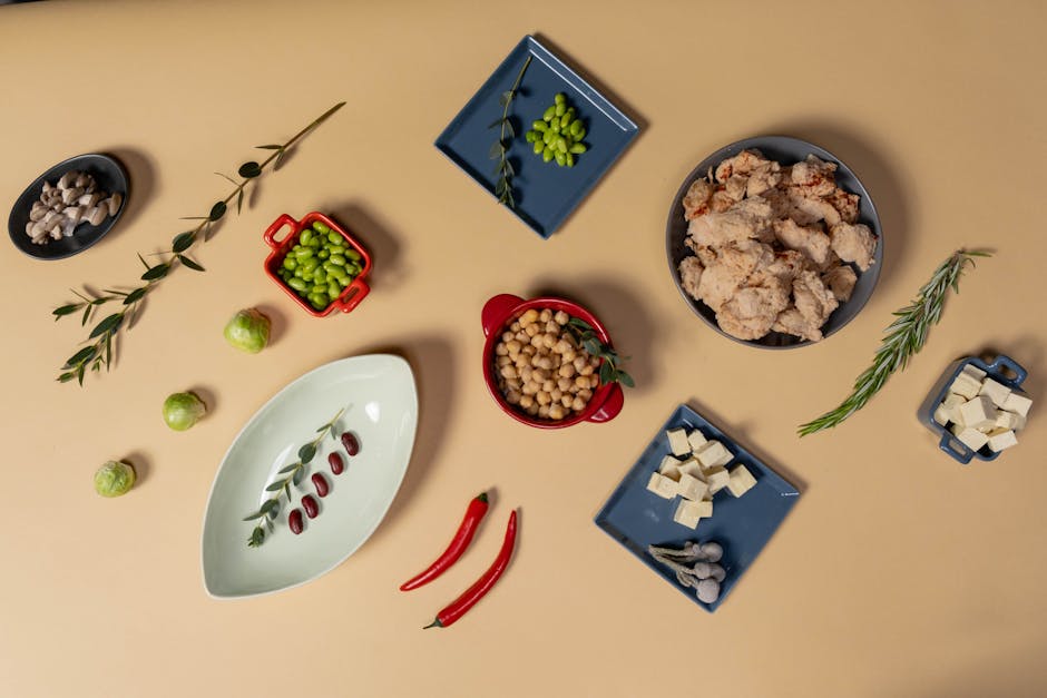 Top view of vegan ingredients including tofu, chickpeas, and spices for a healthy meal.