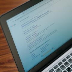 A close-up view of a laptop displaying a search engine page.