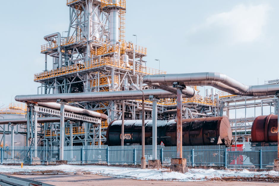 Oil refinery facility with tanker wagons in Trzebinia, Lesser Poland Voivodeship under a clear sky.