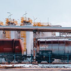 A refinery with industrial train cargo tanks in Trzebinia, Poland on a winter day.