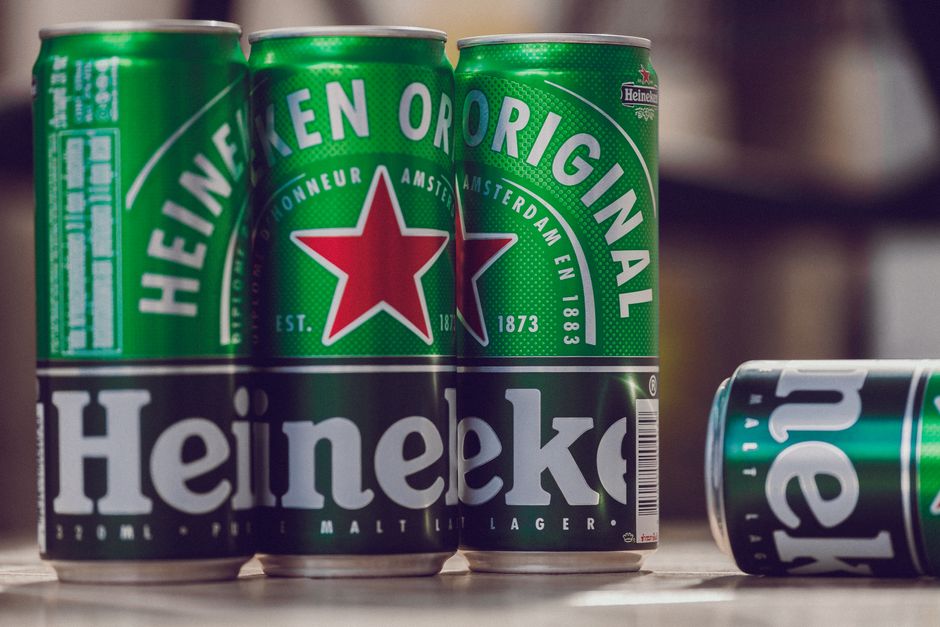 Close-up of Heineken beer cans emphasizing brand and design.