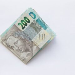 Stack of 200 Brazilian Real banknotes isolated on a white surface, symbolizing wealth and finance.