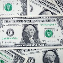 A closeup view of several stacked US dollar bills showcasing currency and financial concepts.