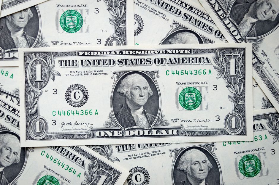 A closeup view of several stacked US dollar bills showcasing currency and financial concepts.