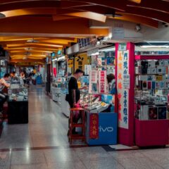 Busy indoor electronics market with modern design and engaged shoppers.