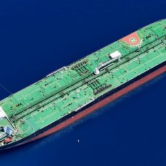 Aerial shot of an oil tanker sailing in the ocean near Vado Ligure, Italy.