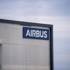 Exterior view of an Airbus factory building with the company logo prominently displayed.