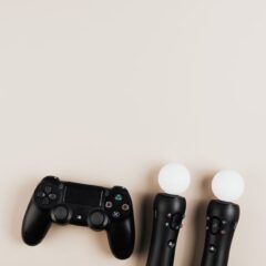 Black gaming controllers arranged on a light background with ample copy space.