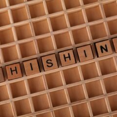 Wooden Scrabble tiles arranged to spell 'Phishing', illustrating online security concepts.