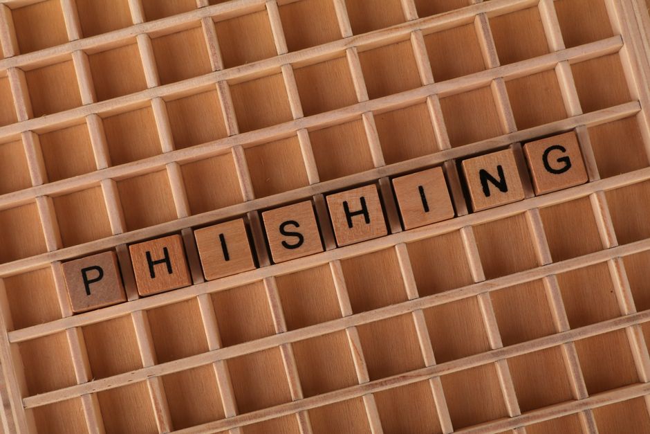 Wooden Scrabble tiles arranged to spell 'Phishing', illustrating online security concepts.