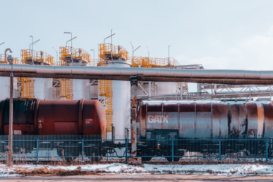 A refinery with industrial train cargo tanks in Trzebinia, Poland on a winter day.