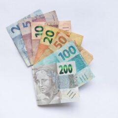 A fan arrangement of colorful Brazilian Real banknotes on a white background showcasing different values.