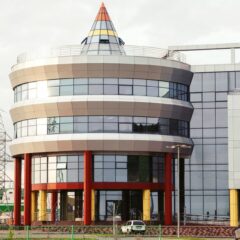 Contemporary office building with unique circular architecture and vibrant accents.