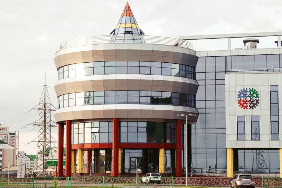 Contemporary office building with unique circular architecture and vibrant accents.